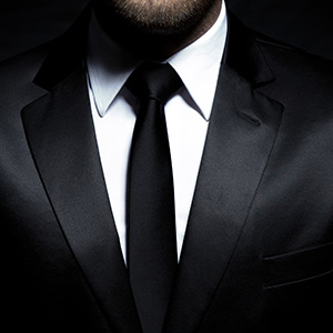 Man in black suit requires tying a necktie